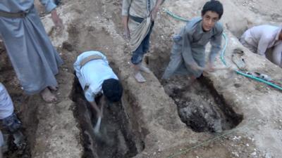 Children digging grave