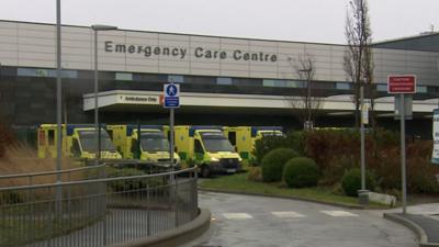 A row of ambulances parked outside an emergency care centre