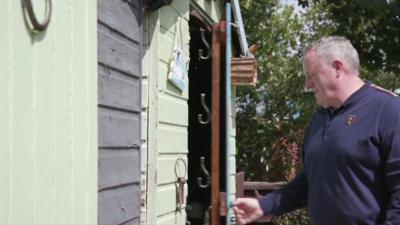 Man entering shed