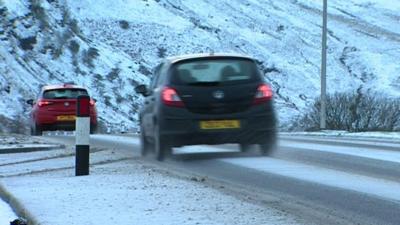 Traffic passing through snow covered roads