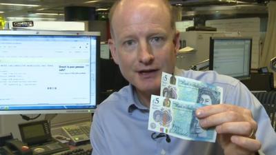 Simon Gompertz with the new £5 notes