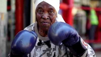 Zodwa Twala, 75 years old, raises her gloves