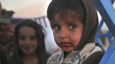 Child fleeing fighting in Iraq