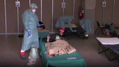 A patient is treated in a warehouse in northern Italy