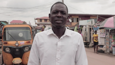 Babagana Aliyu stands on the street where he was arrested.