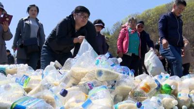 Activists in South Korea pack bottles with food and medicine to send to their neighbours in the North