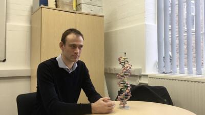 Dr Niek Buurma of Cardiff University sat at a desk