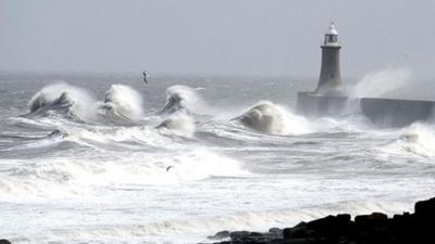 Gales whipping up waves around lighthouse