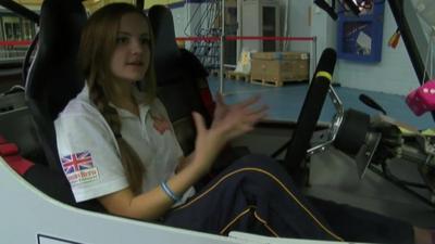 Girl in solar powered car.