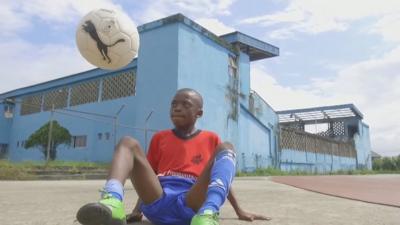 Chinonso Eche on the gorund with a football