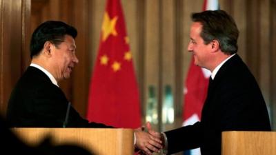 China's President Xi Jinping and Britain's Prime Minister David Cameron shake hands as they attend a joint press conference
