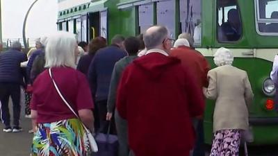 People boarding a tram