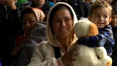 Woman and child carrying soft toy