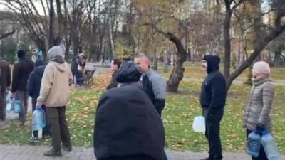 People queue up with water bottle