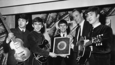 8th April 1963: British pop group The Beatles holding their silver disc. Left to right are, Paul McCartney, George Harrison, Ringo Starr, George Martin of EMI and John Lennon