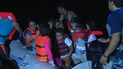 Migrants board a boat to the Greek island of Kos