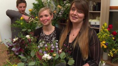 women and men in flower-arranging class