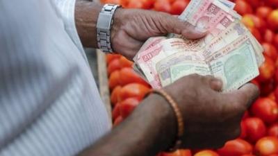 Man counting money at market