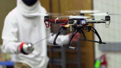 A person fencing with a drone