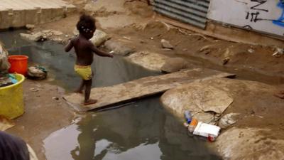 A child walking over a plank