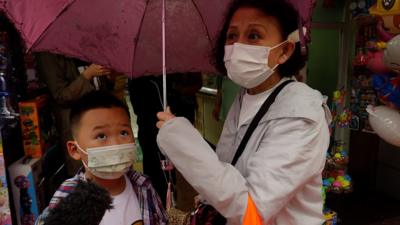 Mother and child being asked about China's new policy