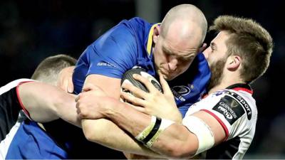 Leinster's Devin Toner is tackled by two Ulster players