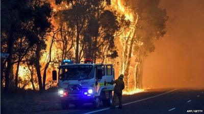 A handout photo taken on January 7, 2016 and released on January 8 by the Department of Fire and Emergency Services shows firefighters battling a fire at Waroona in Western Australia