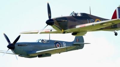 Vintage planes fly in formation as part of a Battle of Britain 75th Anniversary flypast at Goodwood Aerodrome