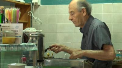 Kostas Miras working in his cafe