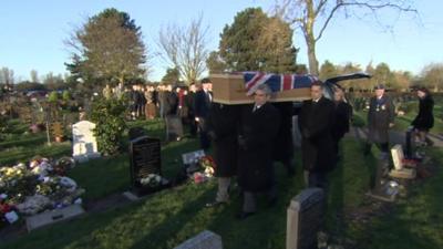 Mourners gathered behind Mr Davies' coffin