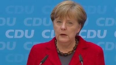 Angela Merkel at podium during press conference