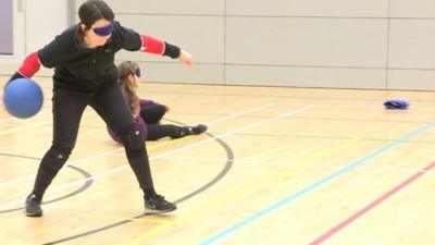 Reporter playing goalball