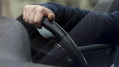 A person holding a steering wheel