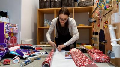 Woman cutting wrapping paper