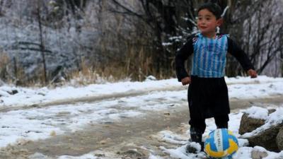 Murtaza Ahmadi, 5, wears a plastic bag jersey as he plays football in Jaghori district of Ghazni province