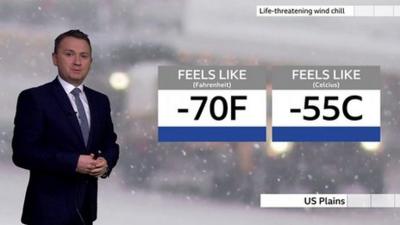 Matt Taylor stands in front of a weather chart looking at wind chill temperatures.