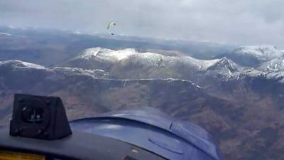 Plane and paraglider over Glen Coe