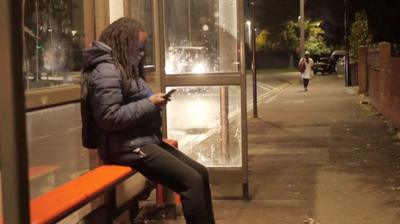 women at bus stop