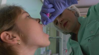 Doctor gives polio vaccine