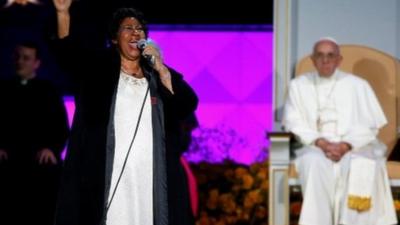 Pope Francis listens as Aretha Franklin performs on stage during the Festival of Families