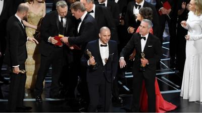 Various actors on stage at Oscars ceremony