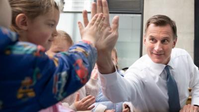 Jeremy Hunt high fives a child