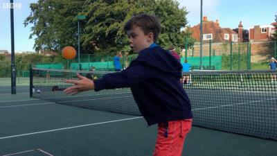 Boy playing pickleball