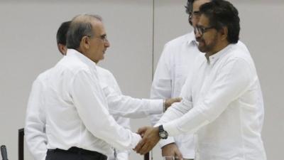 Lead government negotiator for Columbia Humberto de la Calle and the FARC lead negotiator Ivan Marquez shake hands in Havana, Cuba