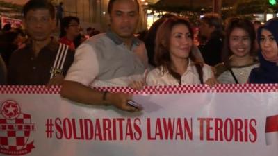 Protesters in Jakarta hold banner