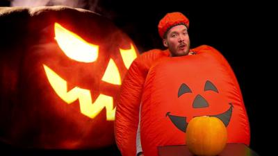 Martin wearing a pumpkin costume.