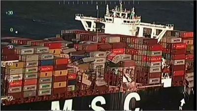 View of side of MSC Zoe cargo ship with crushed containers perched precariously (2 January)