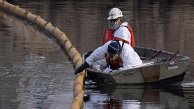 Clean-up crew at work by Huntington Beach in California, 4 October 2021