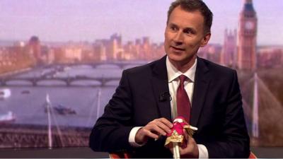 Jeremy Hunt with a doll