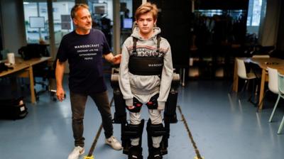 Father and son in robotic suit